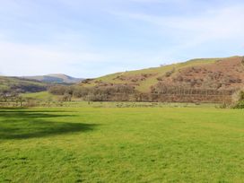 A landscape with hills and grass at Plas Dolguog in Machynlleth
