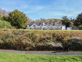A house with a garden and pathway at Plas Dolguog in Machynlleth