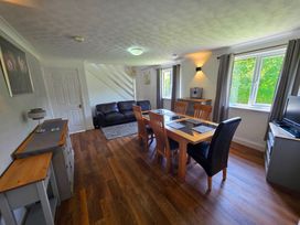 A living room with a dining table and chairs at Lakeview Villa near Liskeard