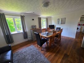 A dining room with a table and chairs at Lakeview Villa near Liskeard