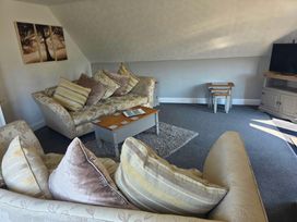 A living room with sofas and a television at Lakeview Villa near Liskeard