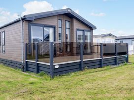 A house with a deck and fence at 8 Summerleaze in Bude