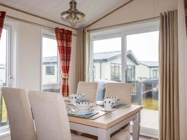 A dining room with a table set for four at 8 Summerleaze in Bude