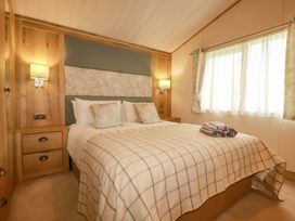 A bedroom with a bed and curtains at 8 Summerleaze Bude