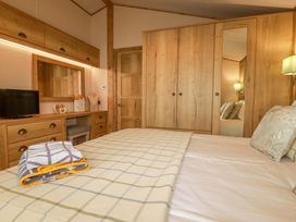 A bedroom with a bed and furniture at 8 Summerleaze in Bude