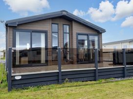 A cabin with a deck and windows at 8 Summerleaze in Bude