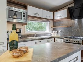 A kitchen with a microwave and coffee maker at Fern View -Kelling Heath Holiday Park Weybourne near Sheringham