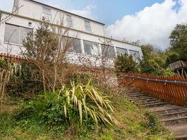 A house with stairs and plants leading to it at Flat 5 in Looe