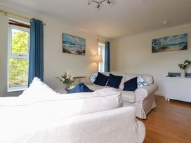A living room with a sofa and lamp at Flat 5 in Looe