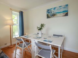 A dining room with a table and chairs at Flat 5 in Looe