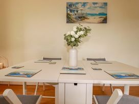 A dining room with a table and chairs at Flat 5 in Looe