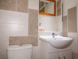 A bathroom with a toilet and sink at Flat 5 in Looe