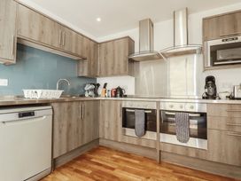 A kitchen with appliances and cabinets at Sea View in Newquay