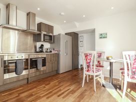 A kitchen with appliances and dining area at Sea View in Newquay