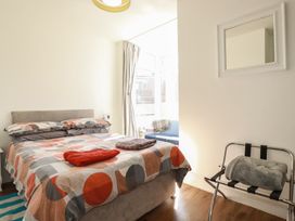 A bedroom with a bed and a chair at Sea View in Newquay