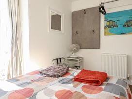 A bedroom with a bed and towels at Sea View in Newquay