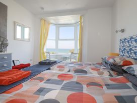 A bedroom with a bed and a view of the sea at Sea View in Newquay
