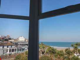 A view from a window showing ocean and beach at Sea View in Newquay