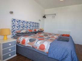A bedroom with a bed and bedside table at Sea View in Newquay