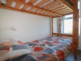 A bedroom with a bunk bed and window at Sea View in Newquay