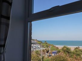 View from a window showing a beach and sea at Sea View in Newquay