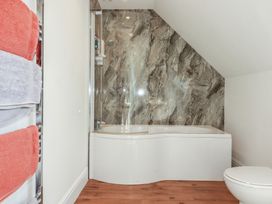 A bathroom with a bathtub and towel rack at Sea View in Newquay