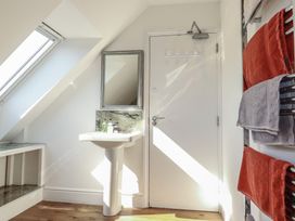 A bathroom with a sink and a mirror at Sea View in Newquay