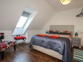 A bedroom with a bed and a chair at Sea View in Newquay