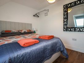 A bedroom with a bed and towels on it at Sea View in Newquay
