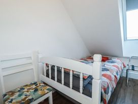 A bedroom with a bed and chair at Sea View in Newquay