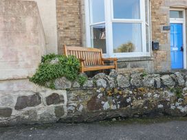 A bench and a stone wall outside a building at Sea View in Newquay