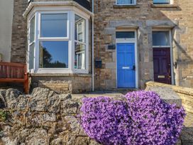 A house entrance with a blue door and flowers at Sea View Newquay