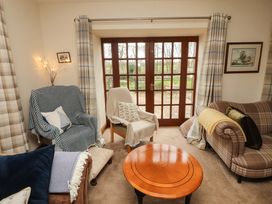 A living room with chairs and a coffee table at High Mill House in Penrith