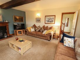 A living room with a sofa and coffee table at High Mill House in Penrith