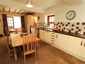 A kitchen with table and chairs at High Mill House in Penrith