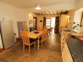 A kitchen with a table and chairs at High Mill House in Penrith