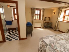 A bedroom with a bed and shower enclosure at High Mill House in Penrith