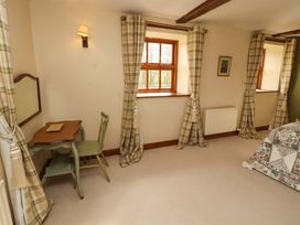 A bedroom with a desk and chair at High Mill House in Penrith