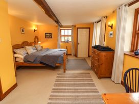 A bedroom with a bed and a drawer unit at High Mill House in Penrith