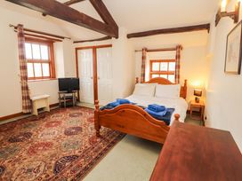 A bedroom with a bed and television at High Mill House in Penrith