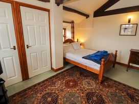 A bedroom with a bed and towels on it at High Mill House in Penrith