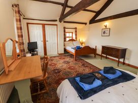 A bedroom with a bed and dresser at High Mill House in Penrith