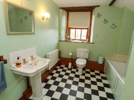 A bathroom with a sink, toilet, and tub at High Mill House in Penrith
