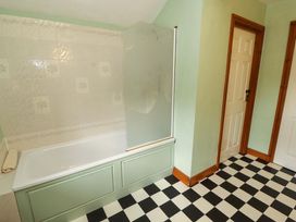A bathroom with a bathtub and shower at High Mill House Penrith