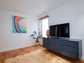 A living room with a television and sideboard at La Casita in Newquay