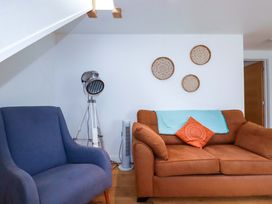 A living room with a sofa and armchair at La Casita in Newquay