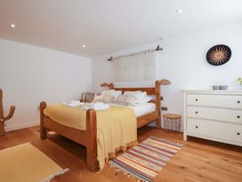 A bedroom with a bed and dresser at La Casita in Newquay