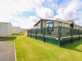 A park home with decking and grass area at 37 Horizon Park in Hartlepool