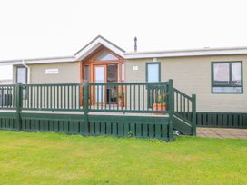 A front view of a property with a deck and potted plants at 37 Horizon Park in Hartlepool