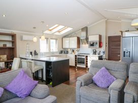 A kitchen with appliances and seating at 37 Horizon Park in Hartlepool